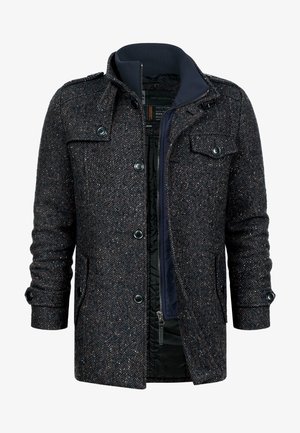 Donkergrijze herengehaken visgraat wollen jas met knoop- en ritssluitingen, klepzakken en een donkerblauwe binnenkraaglaag.