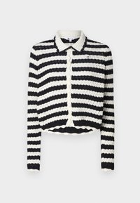 Randig kofta med svart och vit färgskala, med knappstängning fram, en vågig kant och en stickad textur. Krage design.