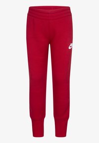 Piros melegítő nadrág rugalmas derékkal, tapered lábakkal és egy fehér Nike logóval a bal oldalon. Puha, texturált anyagból készült.