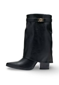 Bottine en cuir noir avec un bout pointu, un talon de hauteur moyenne et un détail de rabat enroulé maintenu par une boucle dorée.