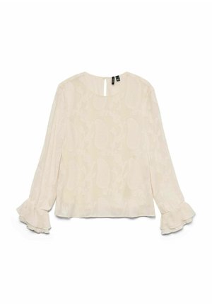 Svijetlo bež bluzica s cvjetnim uzorkom, dugim rukavima i nabranim manžetama. Ima okrugli izrez i otvor na leđima u obliku ključa.