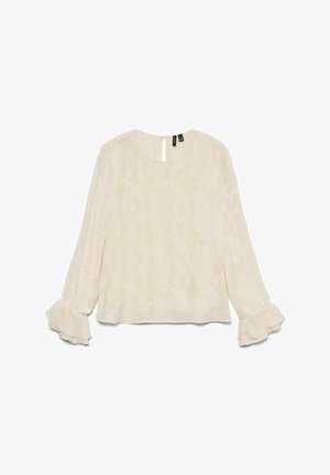 Blusa de color beige claro con un patrón floral, mangas largas y puños con volantes. Presenta un cuello redondo y una apertura en la parte posterior en forma de ojal.