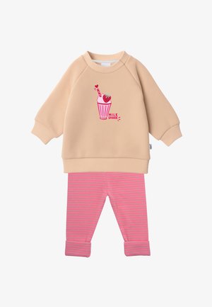 Beige long-sleeve top with pink milkshake graphic and pink striped pants with rolled cuffs, laid flat on white background.