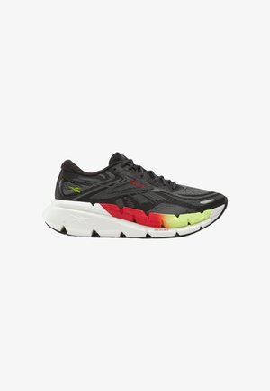Chaussure de course noire avec semelle blanche, avec des accents dégradés rouges et jaunes sur la semelle intermédiaire et une tige en mesh texturé, marquée des logos Reebok.
