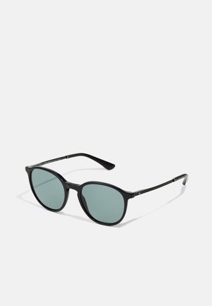 Black sunglasses with a rounded frame, green lenses, and slim metal accents on the temples. Textured frame finish for grip.