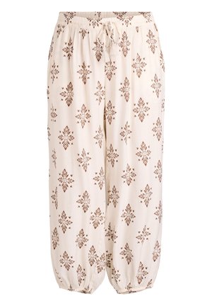 Pantalon ample crème avec motifs symétriques bruns en forme de feuilles, taille élastique avec cordon et poignets élastiques aux chevilles.