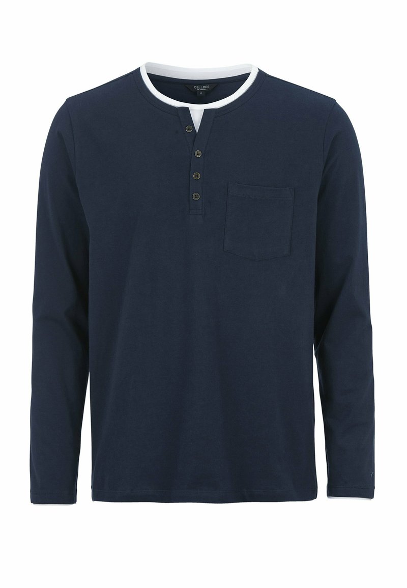 Marinblå långärmad skjorta med rund krage, treknapplås och bröstficka. Mjuk bomullstyg med slät yta.