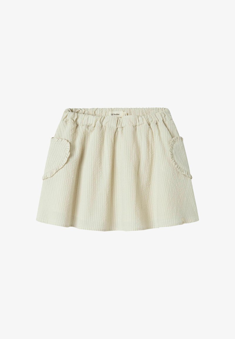 Svetlo bež krilo z teksturirano površino, elastičnim pasom in nabranimi robovi žepov. Ima razširjeno, A-linasto obliko.