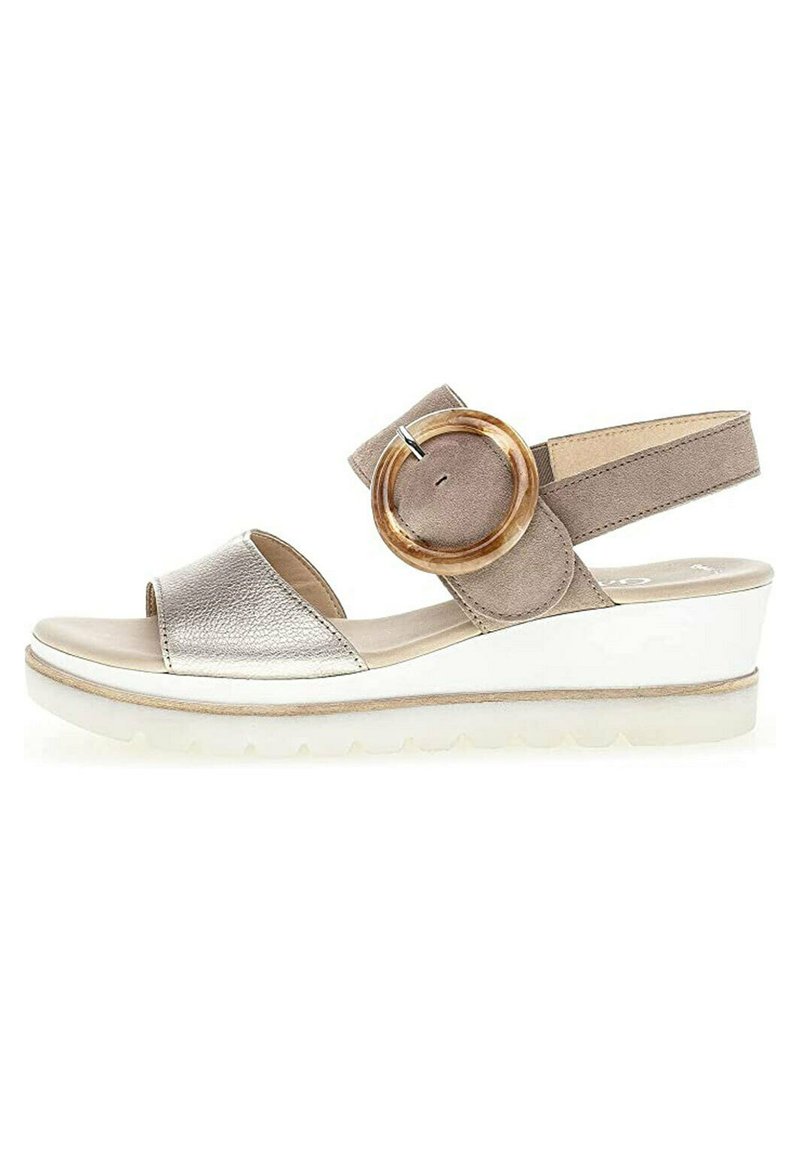 Wedge sandal with a metallic silver leather upper, beige suede strap, round wooden accent, and white rubber sole.