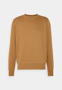 Felpa a maniche lunghe marrone con collo rotondo, con polsini e orlo a coste, presenta un piccolo logo rosso, bianco e blu sul lato sinistro del petto.