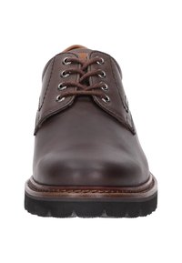 Bruine leren veterschoenen met een ronde neus, stevige zool, metalen oogjes en contrasterende stiksels langs de zoolrand.