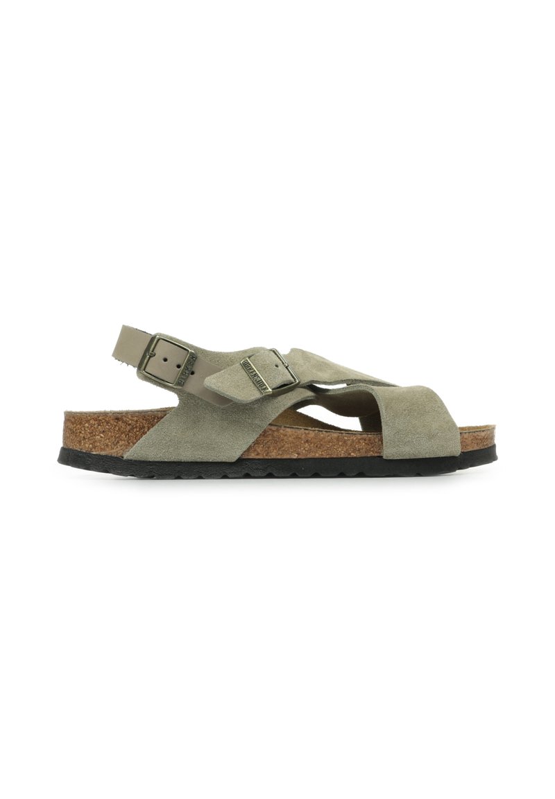 Green suede sandals with a cork footbed, featuring an adjustable strap and an open-toe design. Rubber outsole with a textured finish.