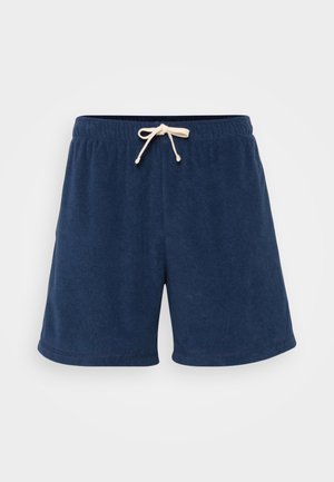 Navy blue shorts made of soft terry fabric, featuring an elastic waistband with a cream drawstring for adjustment and side seam pockets.