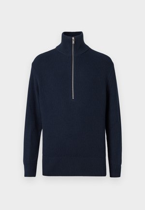 Pullover a coste di colore blu navy con colletto alto e chiusura a mezza zip. Caratterizzato da maniche lunghe e orlo aderente. Texture liscia.