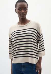Maglione beige con strisce orizzontali nere, ampio scollo a barca e maniche a tre quarti. Texture morbida con una vestibilità rilassata.