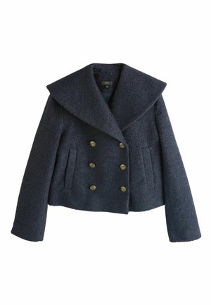 Sõjaväevärvi topeltrinnaline lühike mantel tekstuurse kangaga, millel on suured kraed ja kuus kuldse tooniga nööpi koos kahe küljetaskuga.