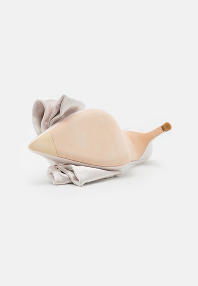 Satin high-heeled shoe with a pointed toe, cream color, and a soft fabric draped around the heel. Glossy sole with a subtle beige accent.