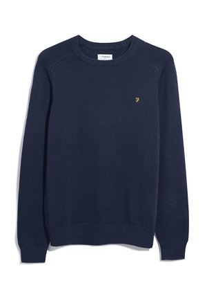 Pull en tricot bleu marine avec un col ras du cou et des poignets côtelés. Présente un petit logo doré sur la poitrine. Design classique et décontracté.