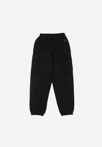 Black sweatpants with an elastic waistband, featuring textured, embroidered designs in varying shapes across the fabric. Adjustable cuffs at ankles.