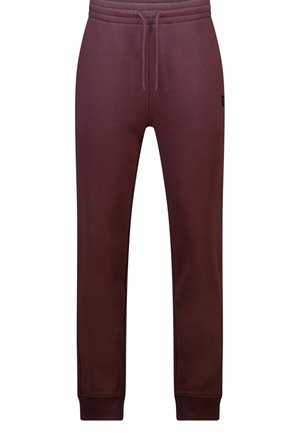Pantalones jogger de color granate con cintura ajustable con cordón, puños acanalados y pequeño parche con logo en la parte superior del muslo izquierdo.