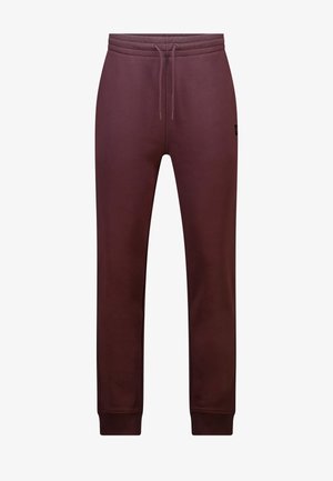 Maroon jogger pants with drawstring waist, ribbed cuffs, and small logo patch on the upper left thigh.