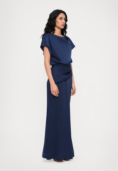 Navy blue dress with a draped top and fitted skirt. Made of smooth fabric, featuring a relaxed fit and floor-length design with subtle sheen.