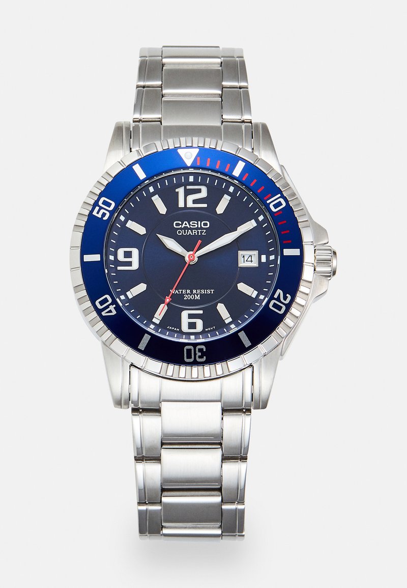 Zilveren roestvrijstalen horloge met blauwe en rode bezel, marineblauwe wijzerplaat, witte uurmarkeringen, quartz beweging, waterbestendig tot 200m en datumweergave.