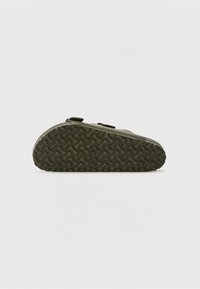 Olive green sandal with a contoured, textured rubber sole featuring a wavy pattern. Two adjustable buckles on the upper for fit.