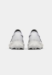 Running shoes with a white mesh upper and black accents. Thick white sole with textured grip pattern. Cushioned heel for support.
