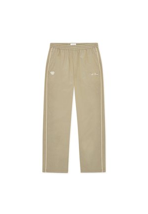 Ανοιχτό μπεζ παντελόνι φόρμας με απαλή υφή, διαθέτει ελαστική μέση με κορδόνι, λευκές πλευρικές ρίγες και κεντημένη λεπτομέρεια λογότυπου.