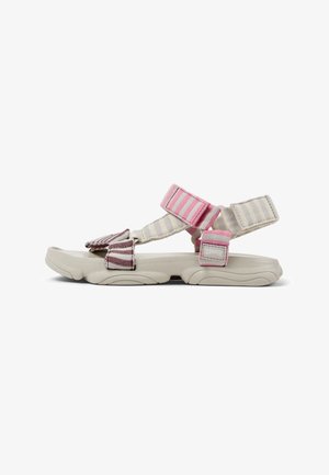 Sporty beige sandal with adjustable striped pink and burgundy fabric straps and cushioned sole, side view on white background.