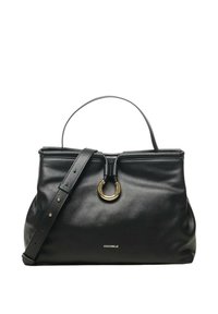 Bolso de cuero negro con asa superior, correa de hombro ajustable, cierre circular dorado y pequeño logo "Coccinelle" en el centro frontal.
