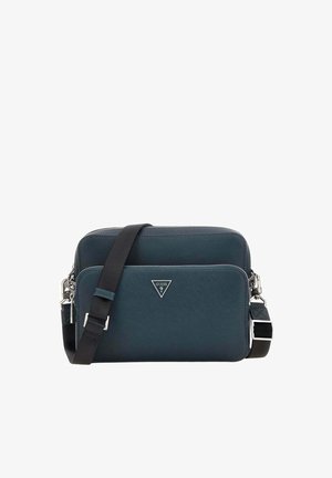 Sac bandoulière compact bleu foncé avec compartiments zippés et sangle noire ajustable, avec un petit logo métallique de la marque à l'avant.