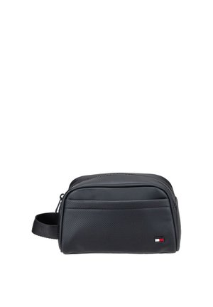 Black rectangular toiletry bag with a front pocket, side handle, and a small red, white, and blue logo in the lower right corner.