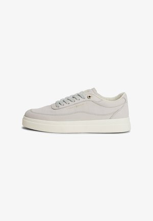 Light gray leather sneaker with a white rubber sole, round toe, and gray laces. Features subtle branding and a smooth texture.