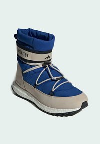 Blå och beige vinterkänga med vadderad krage, snörningsdesign och texturerad sula. Har logotyp och elastiska detaljer för en säker passform.