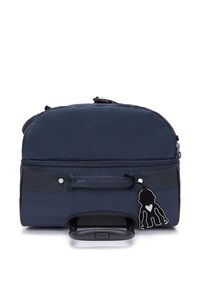 Navy blue wheeled bag with a soft fabric exterior, zip closure, top handle, and a black charm accessory. Features a retractable handle.