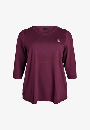 Bordeaux farvet langærmet skjorte med rund halsudskæring, der har en subtil tekstur og et lille logo-tryk på brystet. Casual pasform.