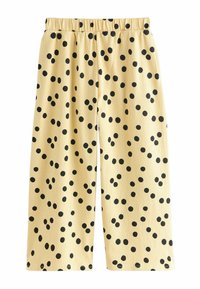 Pantalones culotte amarillos con superficie texturizada, con un patrón de lunares negros y una cintura elástica para mayor comodidad.