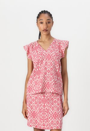 Pink patterned top with V-neck and flutter sleeves, paired with a matching skirt. The fabric features geometric designs in white.