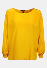 Blouse jaune à manches longues en tissu lisse, dotée d'un col rond et de poignets froncés. Design minimaliste avec une coupe décontractée.