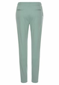 Helle grüne, tapering Hosen mit elastischem Bund, ausgestattet mit zwei Gesäßtaschen und einer glatten Oberfläche.