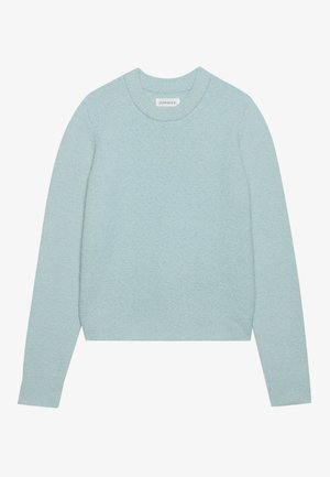 Šviesiai mėlynas megztinis su apvalia iškirpte, ilgomis rankovėmis, tekstūruota medžiaga ir šonuose suprojektuota juosta. Paprastas dizainas, be akivaizdžių raštų ar akcentų.