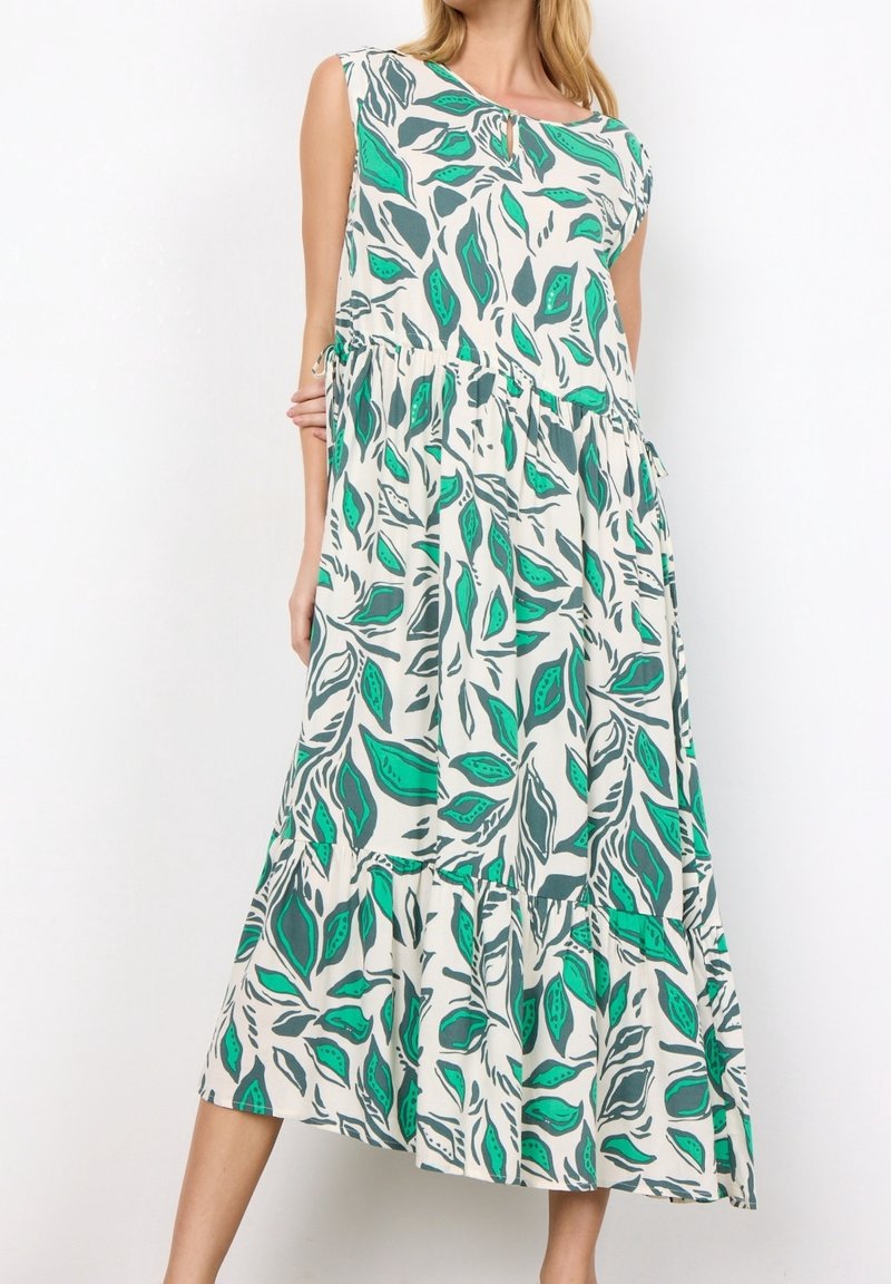 Robe longue présentant un motif feuillu vert et gris sur fond crème, avec un col rond et un design à étages. Tissu en coton.