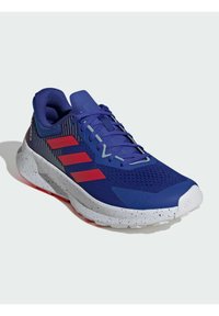 Blue athletic shoe with red accents, mesh upper, padded collar, textured sole, and a speckled white midsole. Lightweight, designed for comfort.