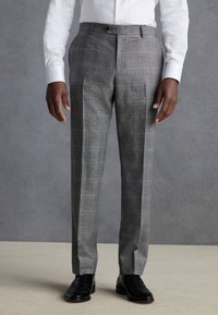 Gray plaid trousers made of structured fabric with a tailored fit, featuring double pleats and a waistband with metal hardware accents.