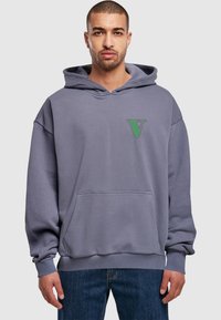 Gray hoodie with a front pocket, ribbed cuffs, and a green "V" logo on the chest. Fabric appears soft with a relaxed fit.