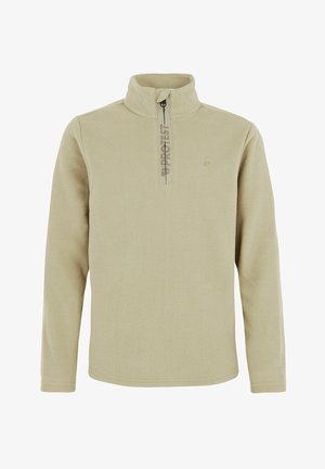 Pull-over en polaire beige avec fermeture éclair quart-de-tour et détail logo, associé à un pantalon imperméable noir et des chaussures noires robustes.