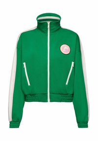 Grön zip-up jacka med hög krage, vita detaljer och två fickor med dragkedja. Har en cirkulär rosa logotyp på framsidan. Elastisk fåll och ärmslut.