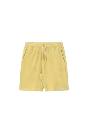 Shorts en éponge jaune pâle avec ceinture élastique, cordon de serrage ajustable, poches latérales et une petite étiquette blanche près de l'ourlet.